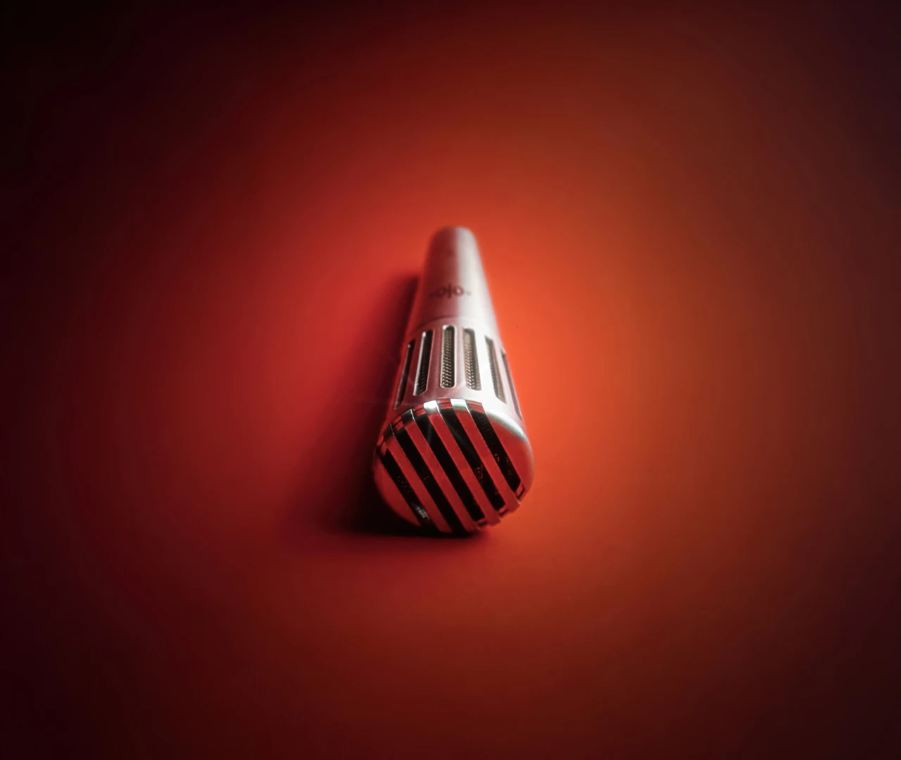 Soyuz V1 Dynamic Microphone illuminated in red lighting showing premium silver finish and precision engineering